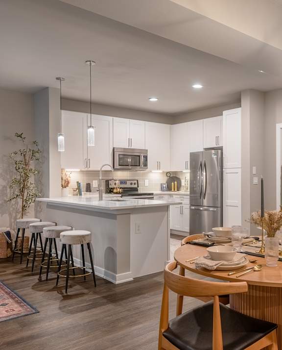 a bedroom with a bed and a door to a bathroom,  The Can Plant,  Luxury Apartments in San Antonio