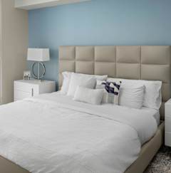 A bedroom with a large bed and a view of the city. at Palma, Florida, 33166