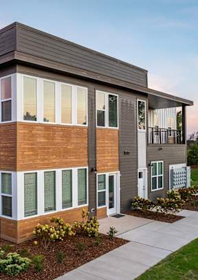 a rendering of a woman walking down a sidewalk in front of an apartment building at The Daniels at Northern Gateway Apartments, Wisconsin