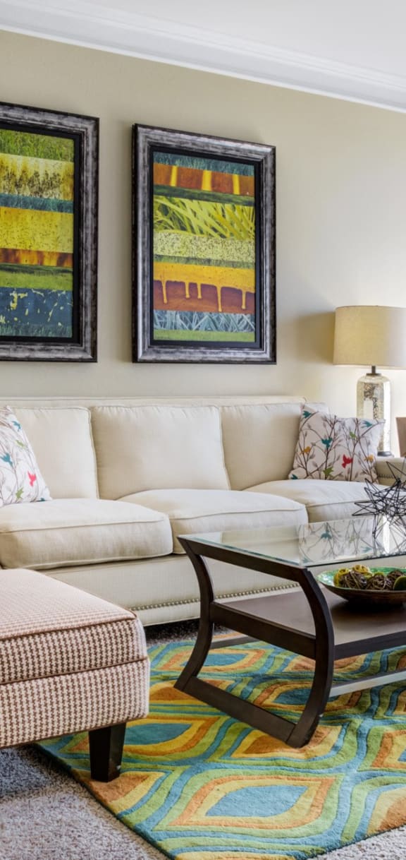 a living room with a couch and chairs and a table