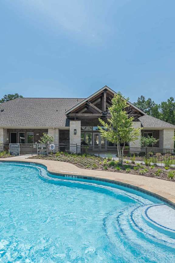 A large house with a pool in front.