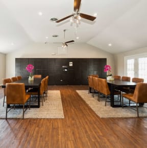 a dining room with a table and chairs and a ceiling fan