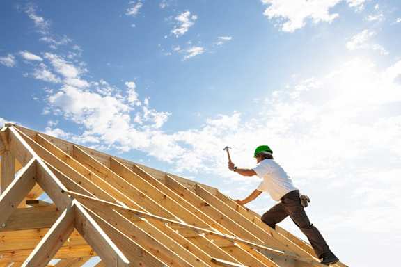 a construction worker working on top of a roof