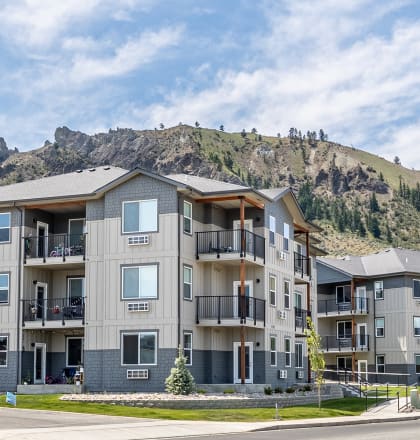an apartment complex with a mountain in the background
