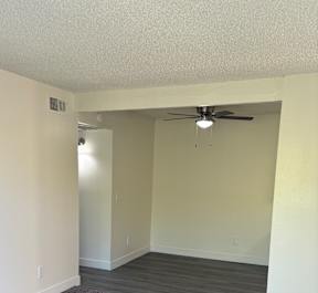 A white table with a fan on the ceiling.