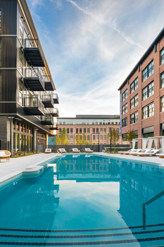 a swimming pool in the middle of two apartment buildings