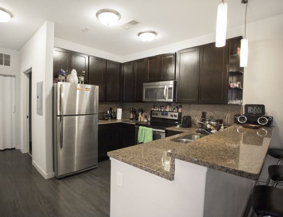 a kitchen with stainless steel appliances and granite counter tops