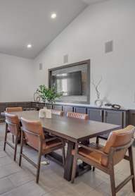 a dining room with a wooden table and chairs