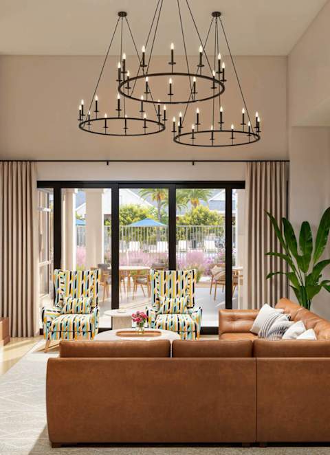 a living room with a white couch and two white chairs with blue and white pillows at Arterra Apartment, Surprise, AZ, 85374