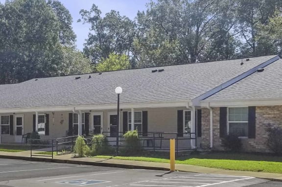 the front of a building with a parking lot