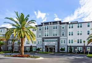 A large building with a parking lot in front of it.