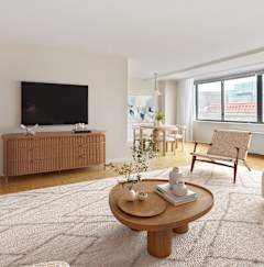 a living room with black furniture and a tv