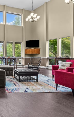an open living room with large windows and furniture
