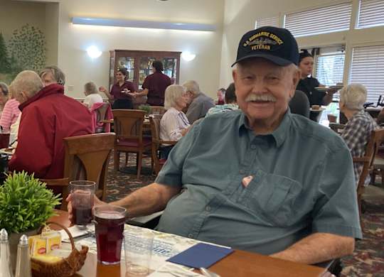 Two residents dining together in community room at Hilltop Commons Senior Living Apartments, Grass Valley, California