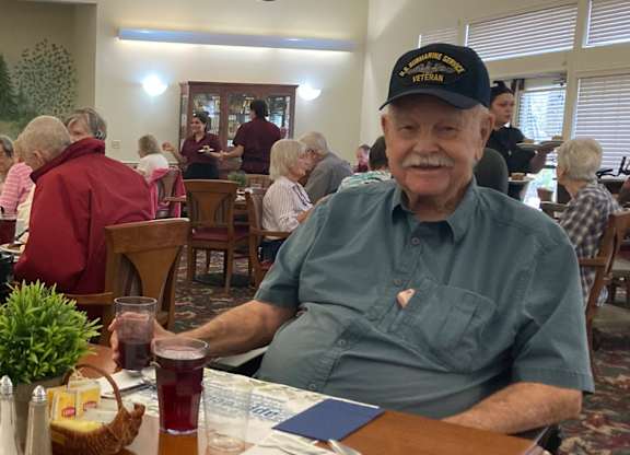 Two residents dining together in community room at Hilltop Commons Senior Living Apartments, Grass Valley, California