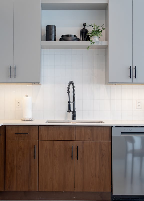A modern kitchen with wooden cabinets and stainless steel appliances.