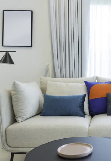a sofa with colourful cushions in a 555 waverly unit