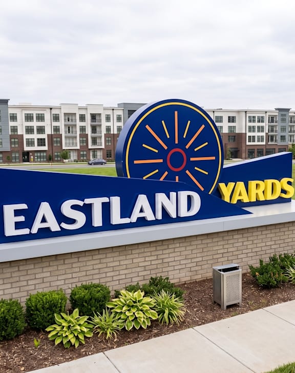 A sign that says Eastland Yards in front of a building.