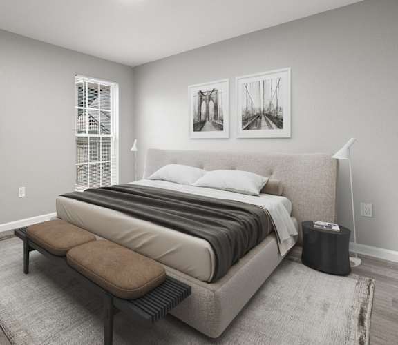 A bedroom with a large bed and a bench in front of it.