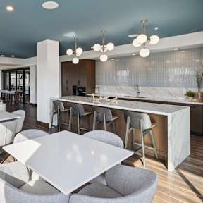 A modern kitchen and dining area with a large island and chairs.