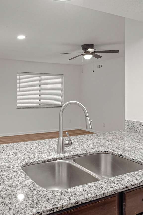 Kitchen with countertop, sink and faucet at Mammoth at the Orchard Apartments, Rogers