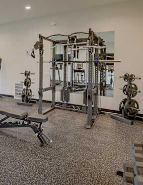 A spacious gym with a variety of equipment including treadmills, weights, and exercise machines.