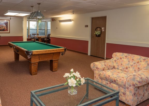 a large dining room with tables and chairs and windows at Hilltop Commons Senior Living, Grass Valley, CA
