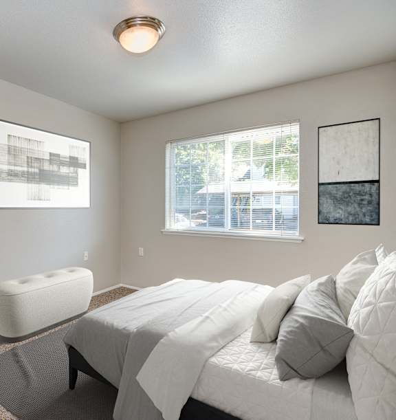 A bedroom with a large bed and a window.
