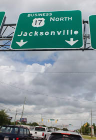 a highway sign showing directions and and j