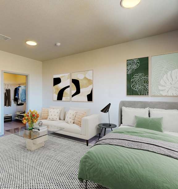 A bedroom with a large bed and a couch. at Railside at Wadsworth Station, Lakewood, CO
