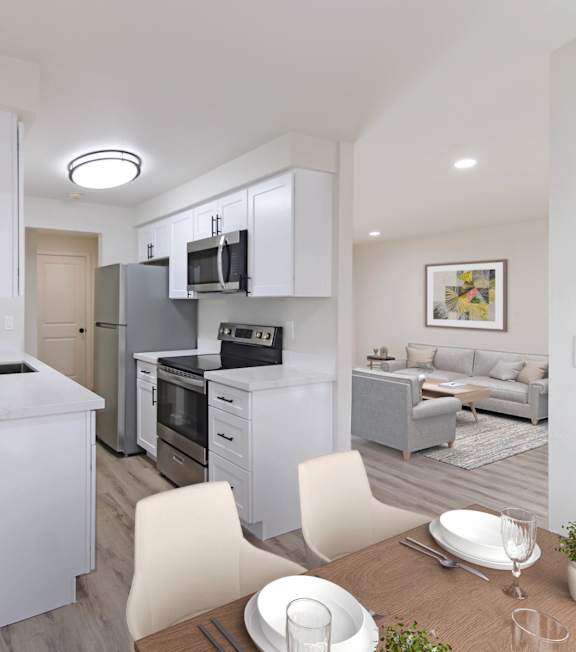 A kitchen with white cabinets and a patterned rug on the floor.