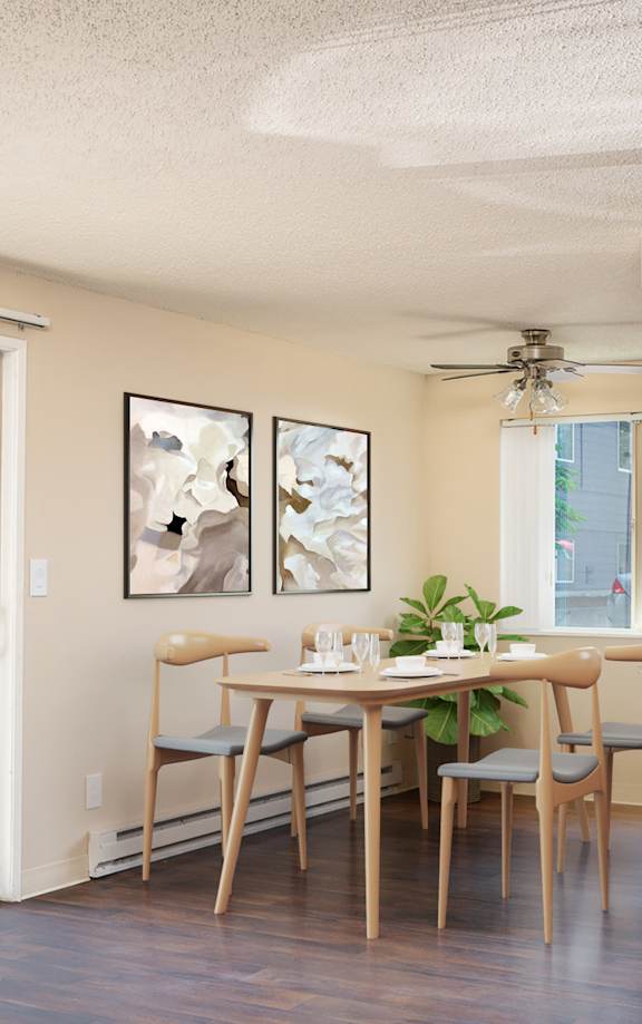 the view of a living room and a kitchen with a table and chairs