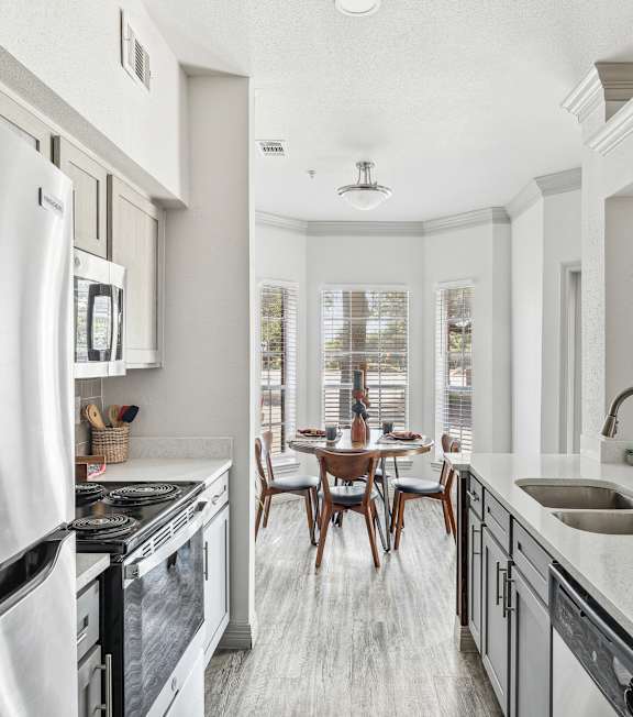 A modern kitchen with a large island and stainless steel appliances.