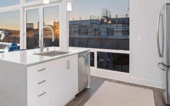 a white kitchen with a large group of windows
