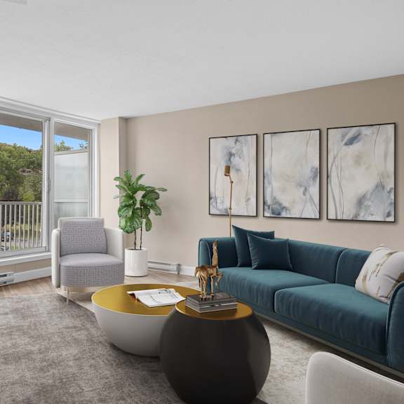A living room with a blue couch and a grey chair.