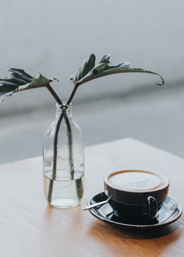 a flower and a coffee on a table at The Deco at 5211, Atlanta, Georgia, 30341