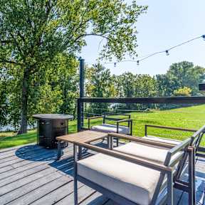a patio with a table and chairs and a fire pit at Brightwaters Apartments, Little Rock, Arkansas
