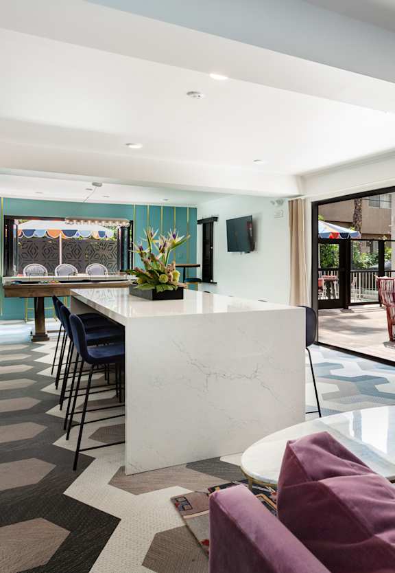 a living room with a kitchen and a dining room