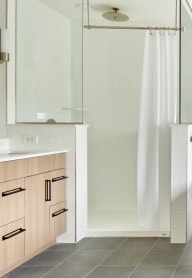a bathroom with a tub and a sink and a shower
