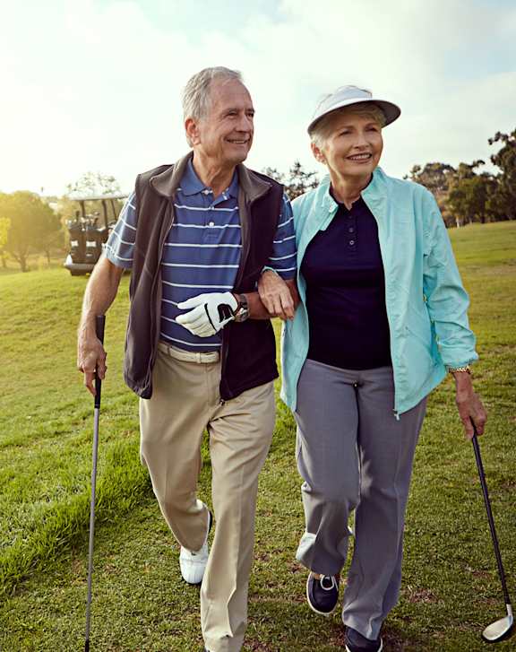 An elderly couple walking on a golf course.at Cornerstone Commons, Iowa, 50131