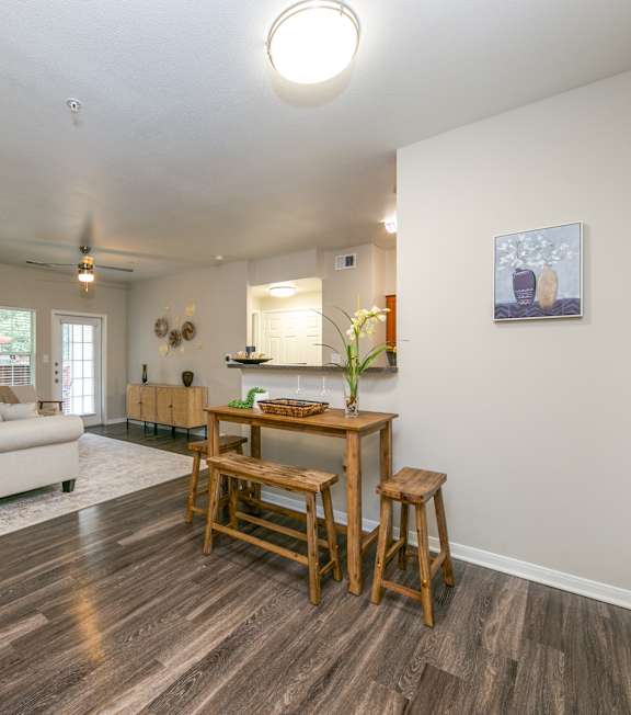 A kitchen with wooden cabinets and a black microwave.
