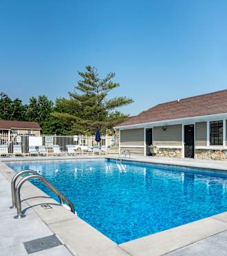 The sparkling swimming pool at The Village at Sandstone Apartments in Greenwod, Indiana, 46142