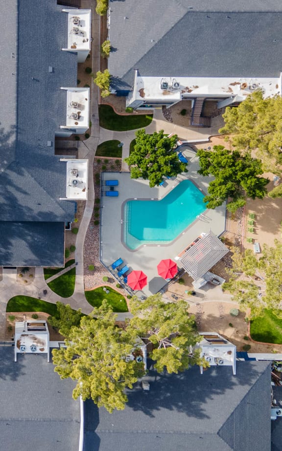 a birds eye view of the resort with pools and trees