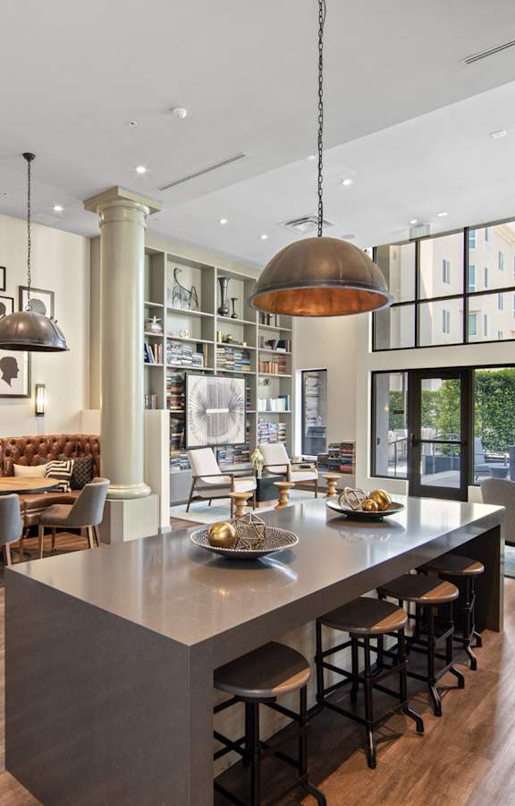 A modern kitchen with a bar area and a dining area.