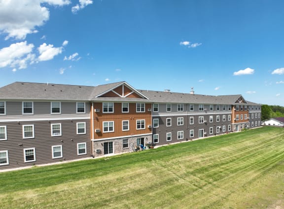 a large building with a grass field in front of it