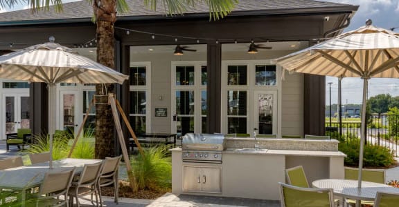 a patio with tables and umbrellas and a bar