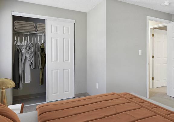 a bedroom with a bed and a closet with closets at Mariner's Hill Apartments, Massachusetts