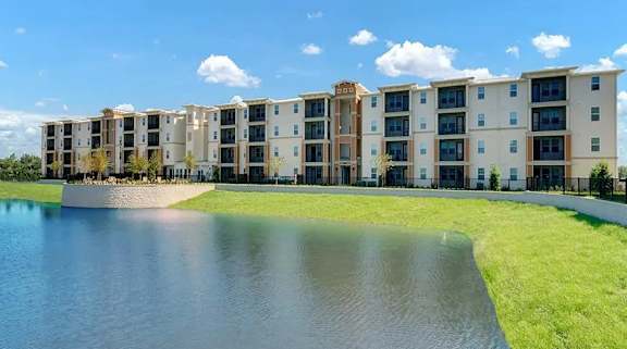 a large pond in front of an apartment building