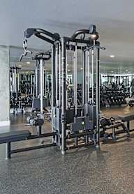 A gym with a variety of equipment including a leg press machine.