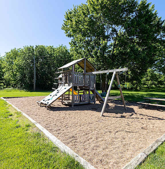 a playground with a swing set in a park